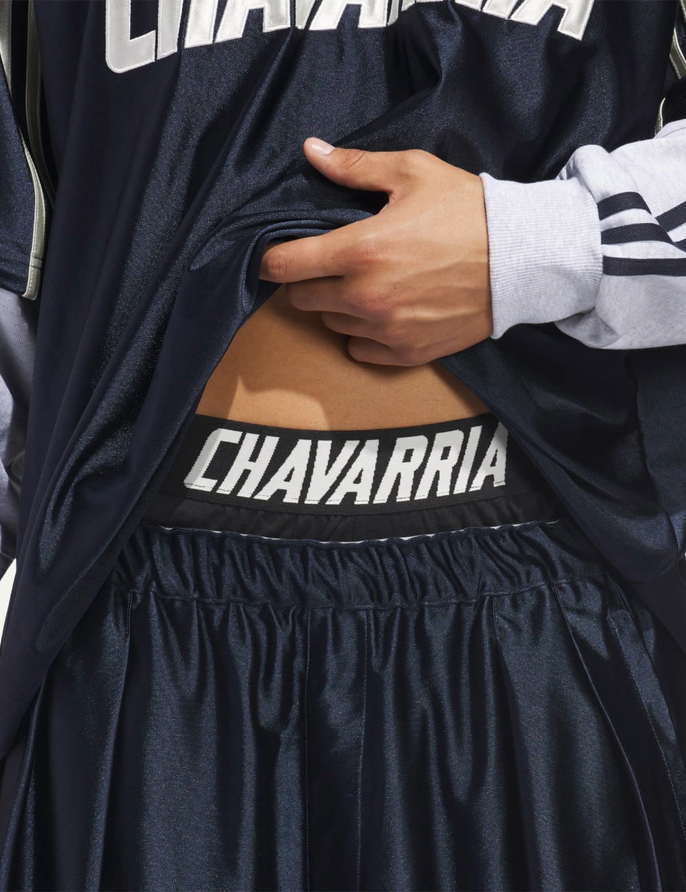 Detail shot showing striped elastic waistband of Adidas x Chavarria House shorts.
