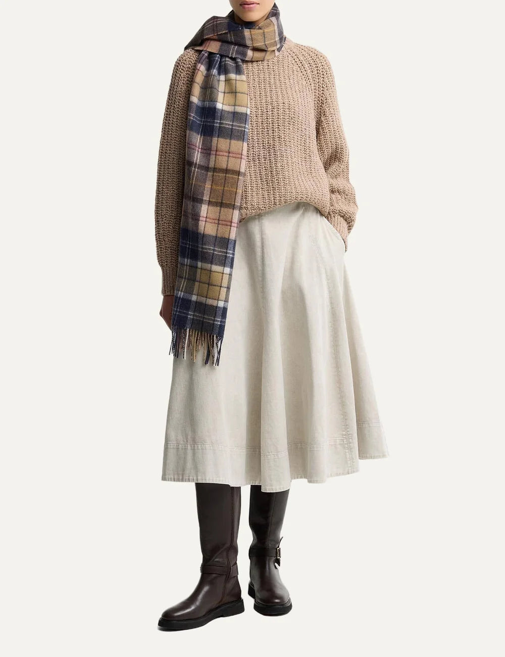 Barbour women's lambswool scarf with beige brown and navy patchwork tartan pattern and fringe trims model