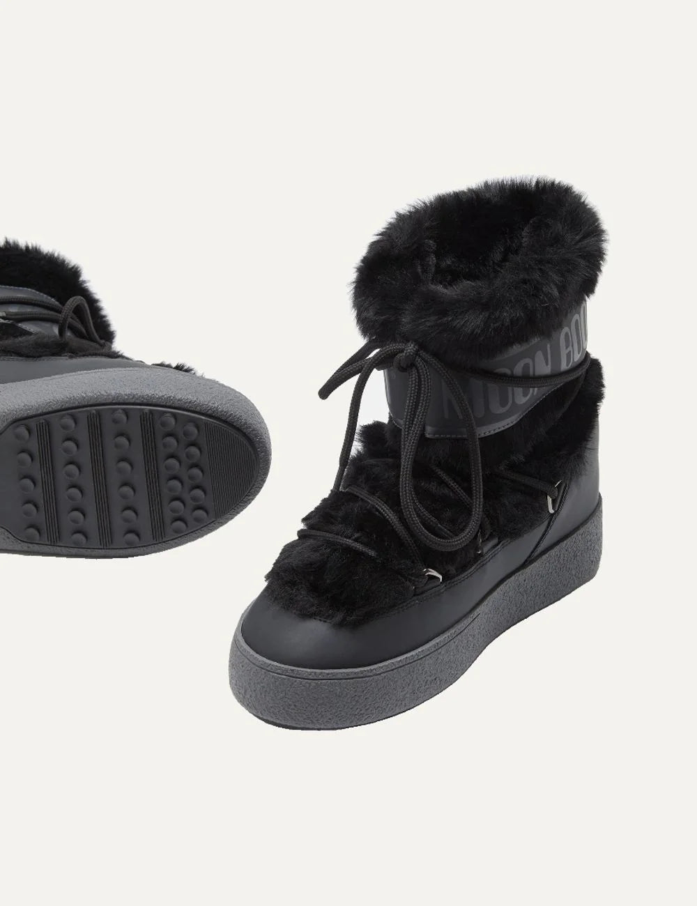 Moon Boot women Ltrack Low black faux fur boots with criss-cross laces and rubber sole pair front view