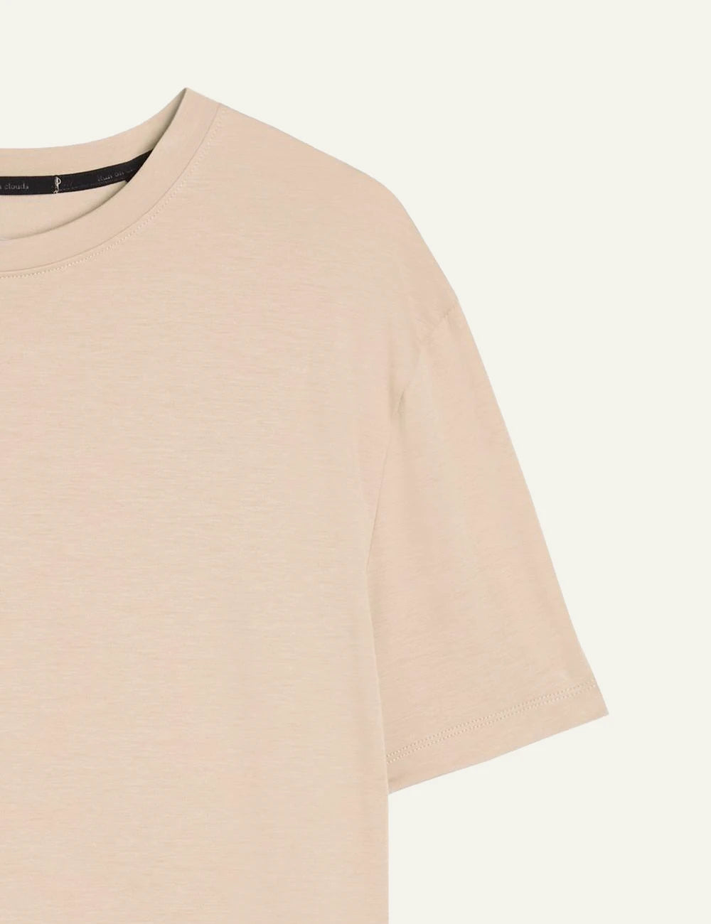 On beige cotton T-shirt close-up shoulder detail