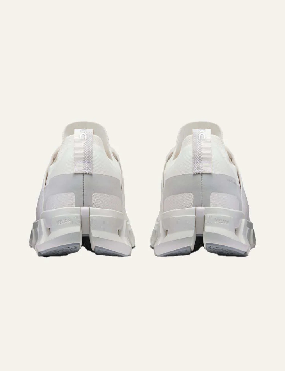 On men's white running sneakers with breathable mesh upper, grey details, CloudTec cushioning and Helion foam back