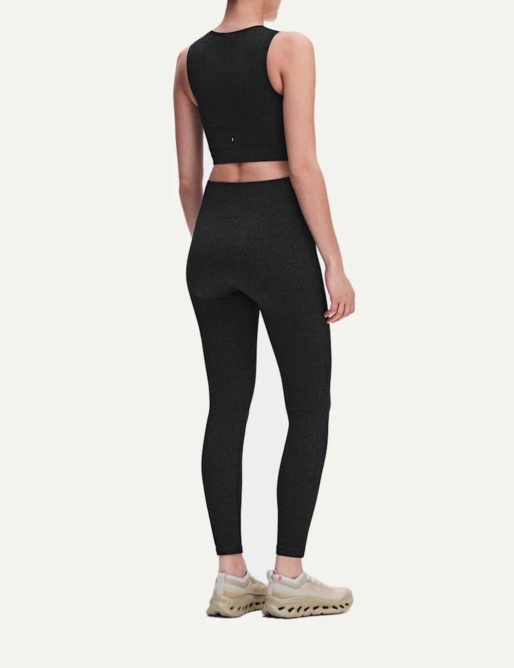 On women's dark grey heathered crop athletic top with sleeveless design, round neckline, soft textured knit, four-way stretch fabric and bonded edges back