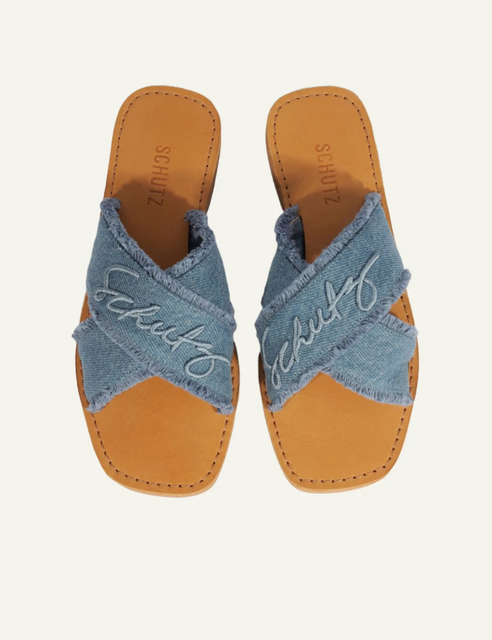 Schutz denim flat sandal with frayed X straps and logo detail top view
