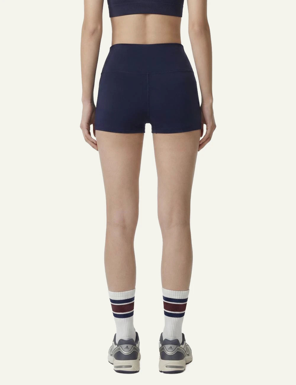 Sporty and Rich mini biker shorts navy high waist back view