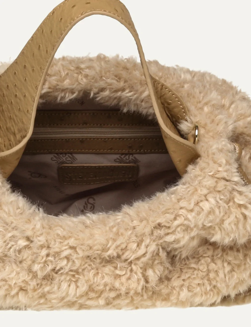 Steve Madden women's cream faux shearling handbag with curly plush texture, beige ostrich effect double top handles, matching front belt and oversized gold tone buckle, interior view