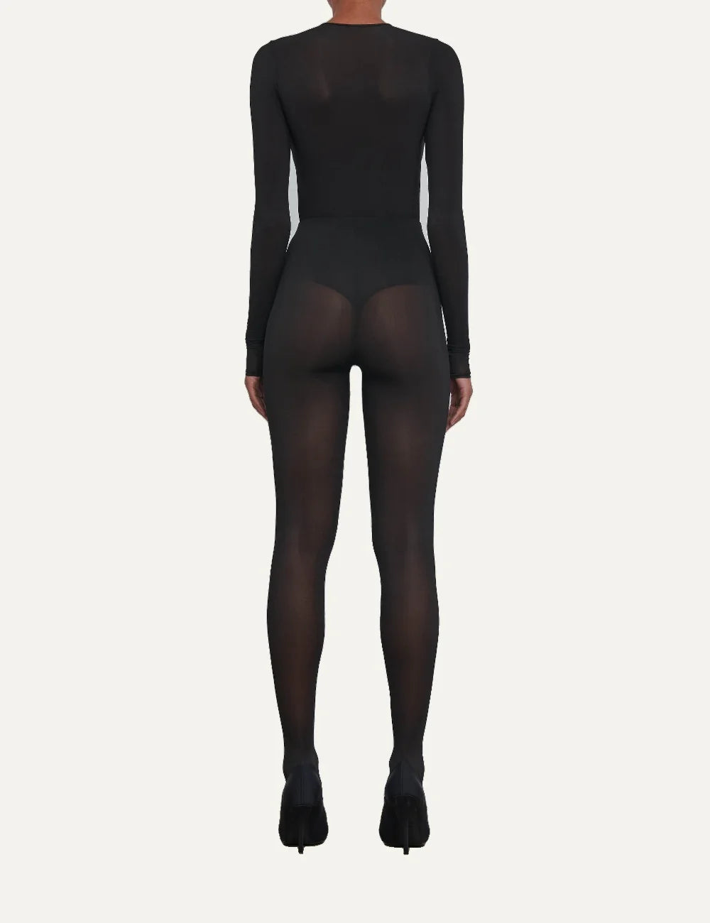 Wardrobe NYC women's black sheer tights in Italian stretch fabric featuring a translucent finish, high elasticated waist, form-fitting silhouette and full-length legs back