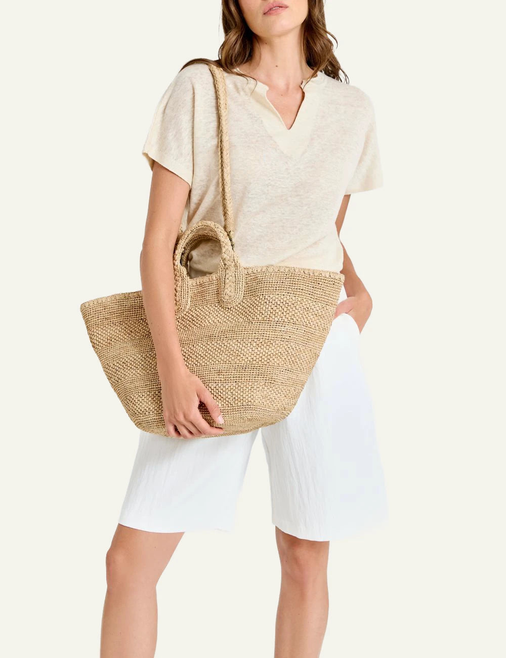 Ibeliv Soma raffia tote bag natural woven shoulder strap front model view