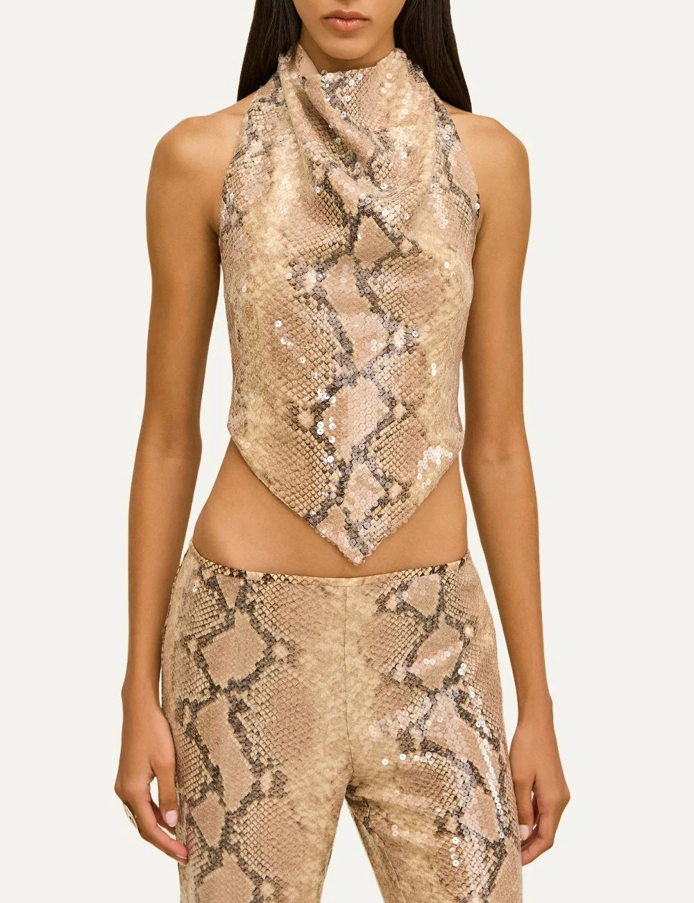 Cult Gaia Dionea beige python print silk crepe sequin top with draped high neckline, sleeveless design and pointed handkerchief hem.