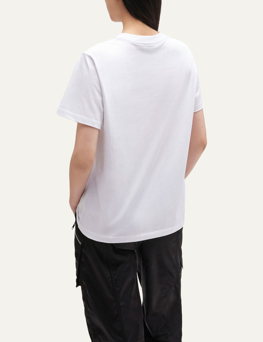 Back view of white Ganni T-shirt worn by model, showing plain white back and relaxed fit.