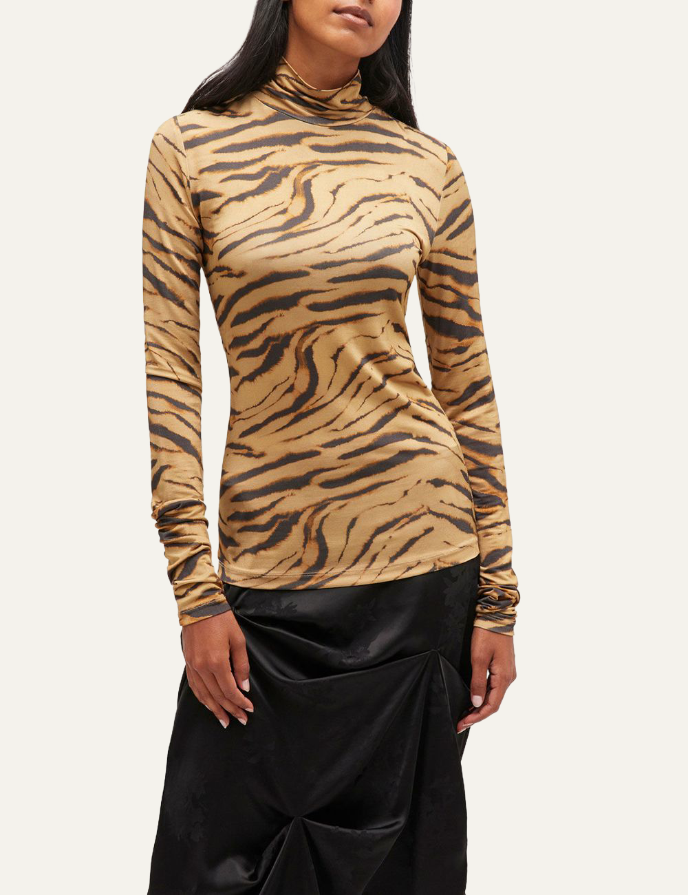 Beige Ganni tiger print turtleneck top with long sleeves displayed on flat background.