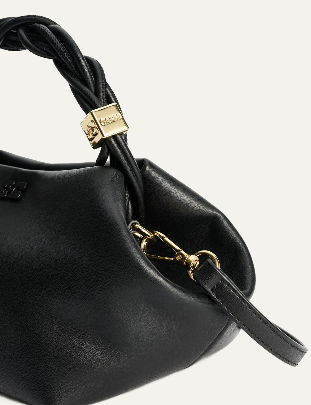 Close-up of black Ganni Bou Bag Small strap hardware.