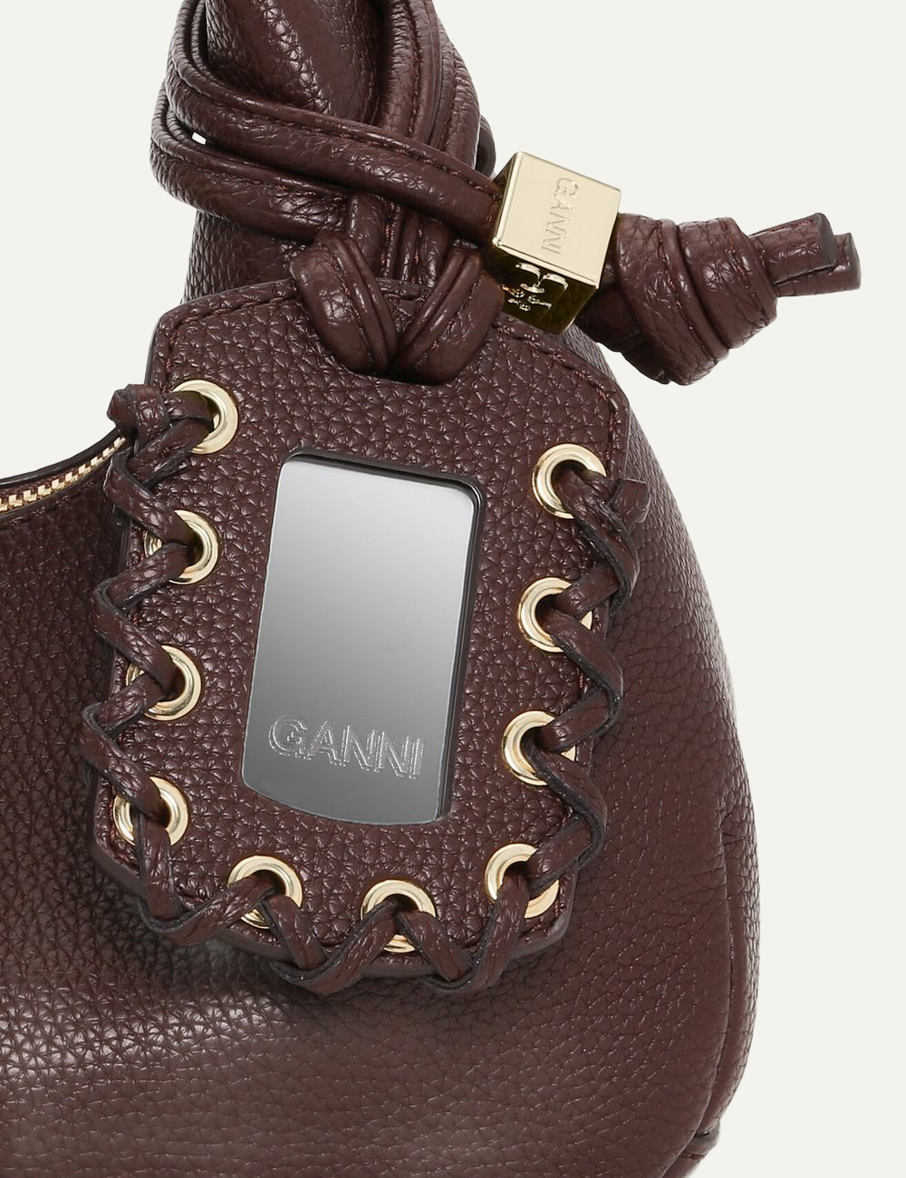 Close-up of Ganni Hobo Mini mirror charm.