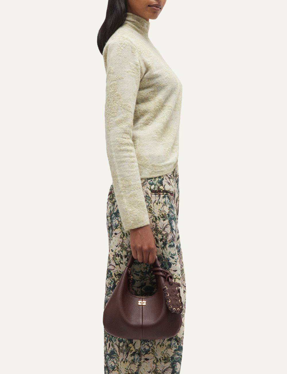 Ganni Hobo Mini grained bag carried by model.