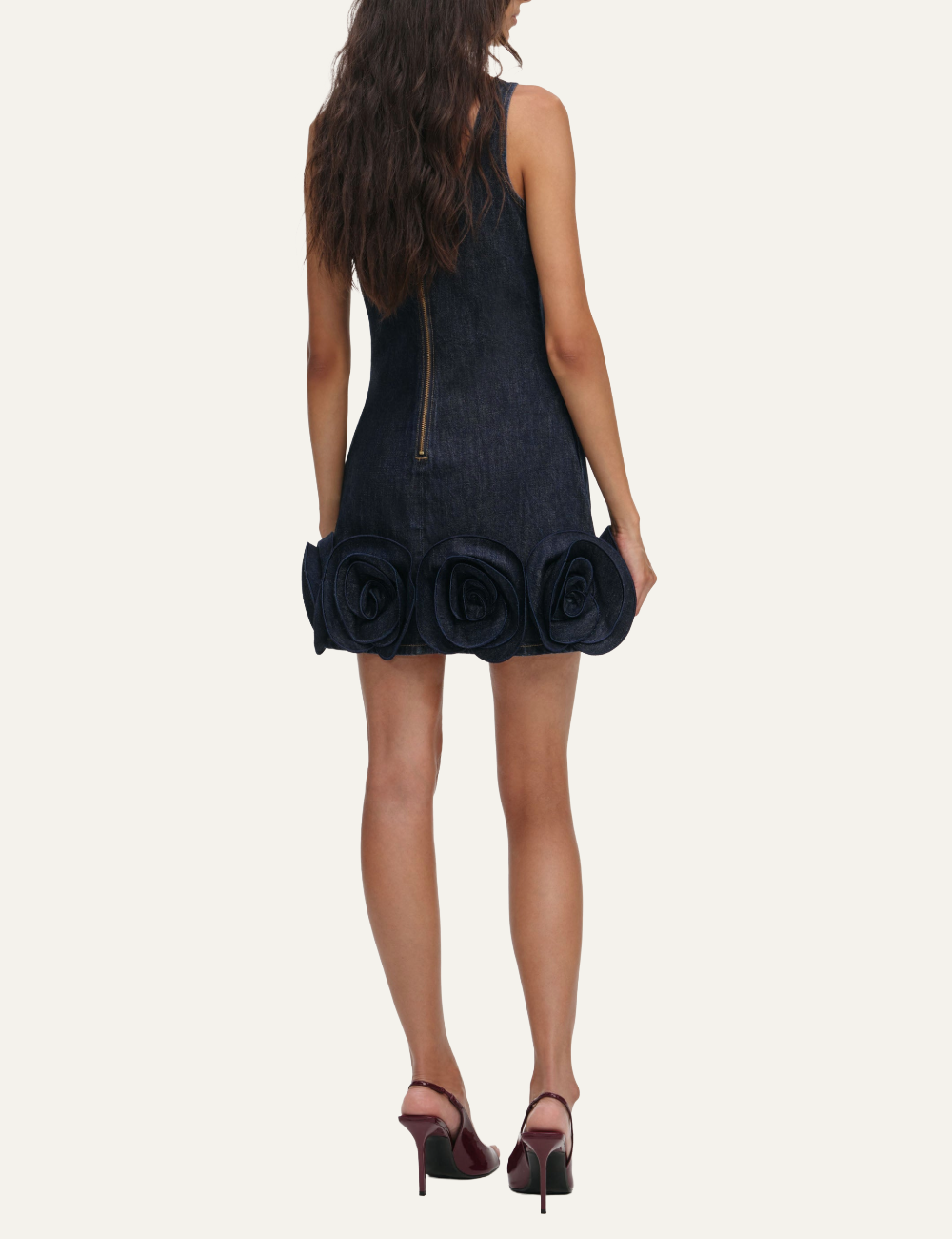 Dark blue denim mini dress with 3D rosette details along the hem back.