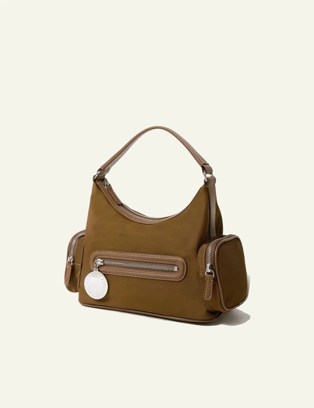 Stella McCartney shoulder bag in camel vegan leather with front zip pocket, side compartments and logo coin charm, front view