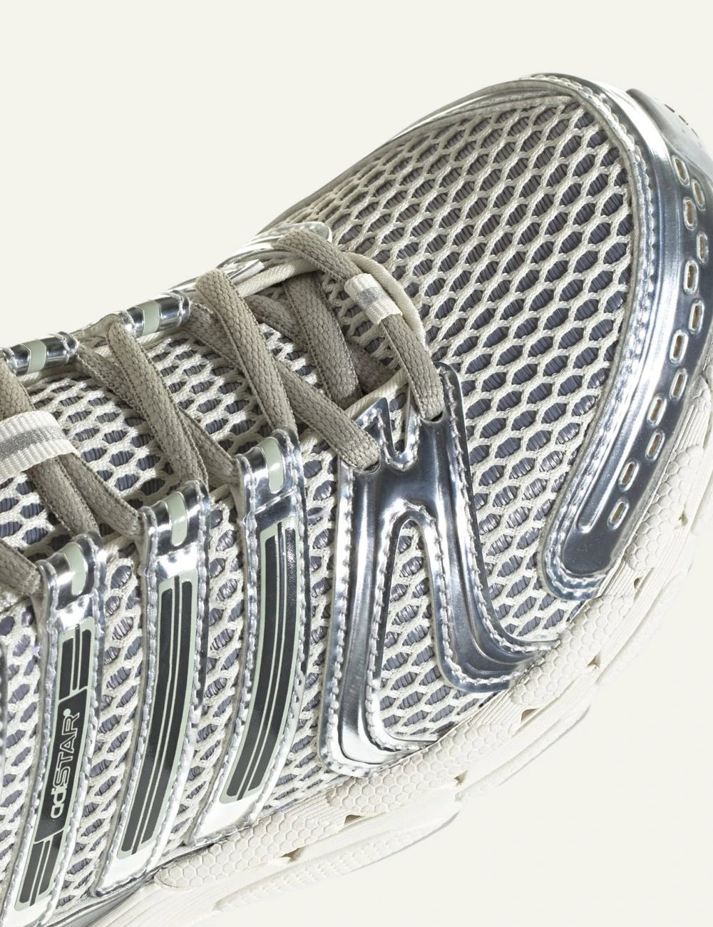 adidas Originals Adistar Control 5 sneakers in Off White with silver metallic overlays angled