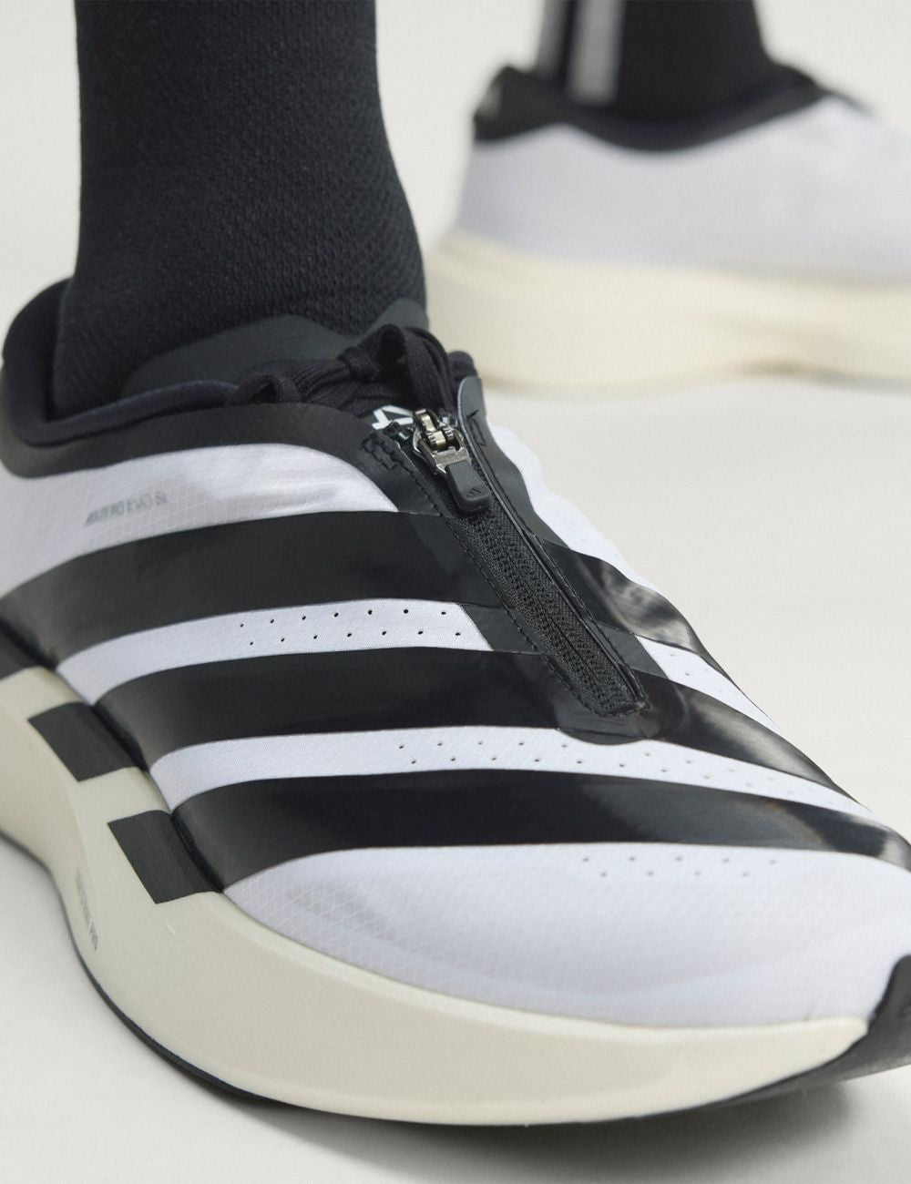 Women's adidas Adizero EVO SL Zip running shoes in white and black with LIGHTSTRIKE PRO midsole and zip closure front