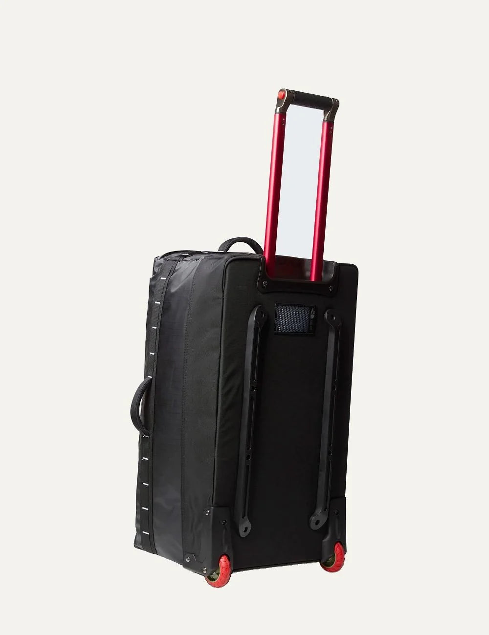 The North Face Base Camp Voyager Roller 29 black rolling travel suitcase with white logo, red telescopic handle and two wheels back