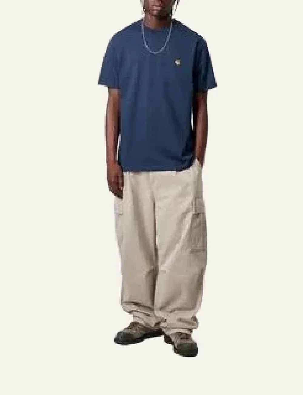 Model wearing Carhartt WIP Chase T-Shirt jupiter blue with beige cargo pants, casual streetwear outfit.