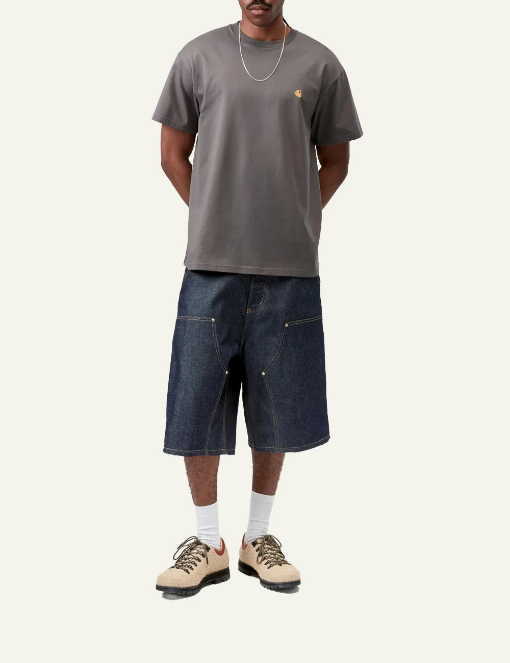 Model wearing Carhartt WIP Chase T-Shirt porphyry grey with denim shorts, casual streetwear outfit.