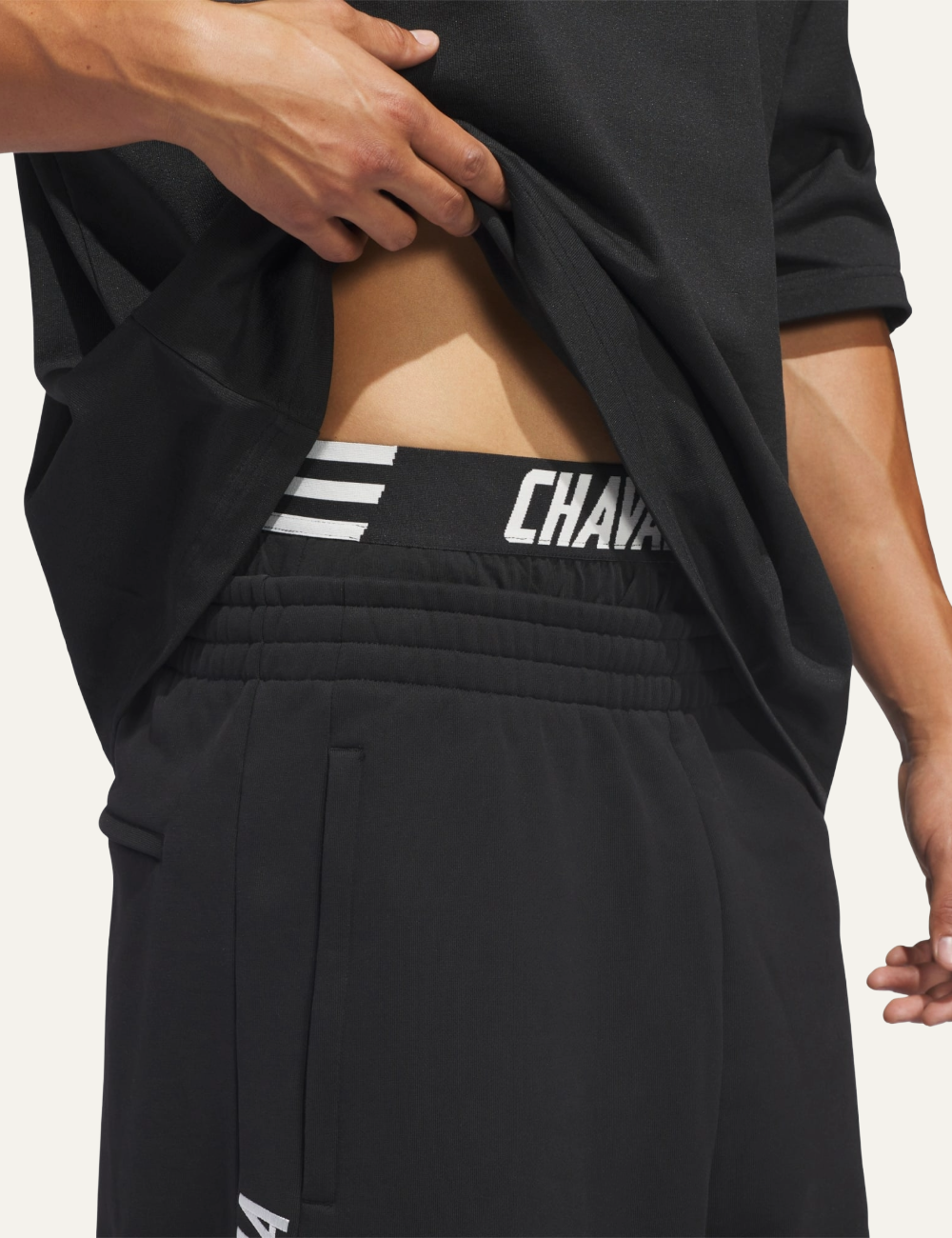 “Close-up of CHAVARRIA branded waistband on Adidas House shorts.”