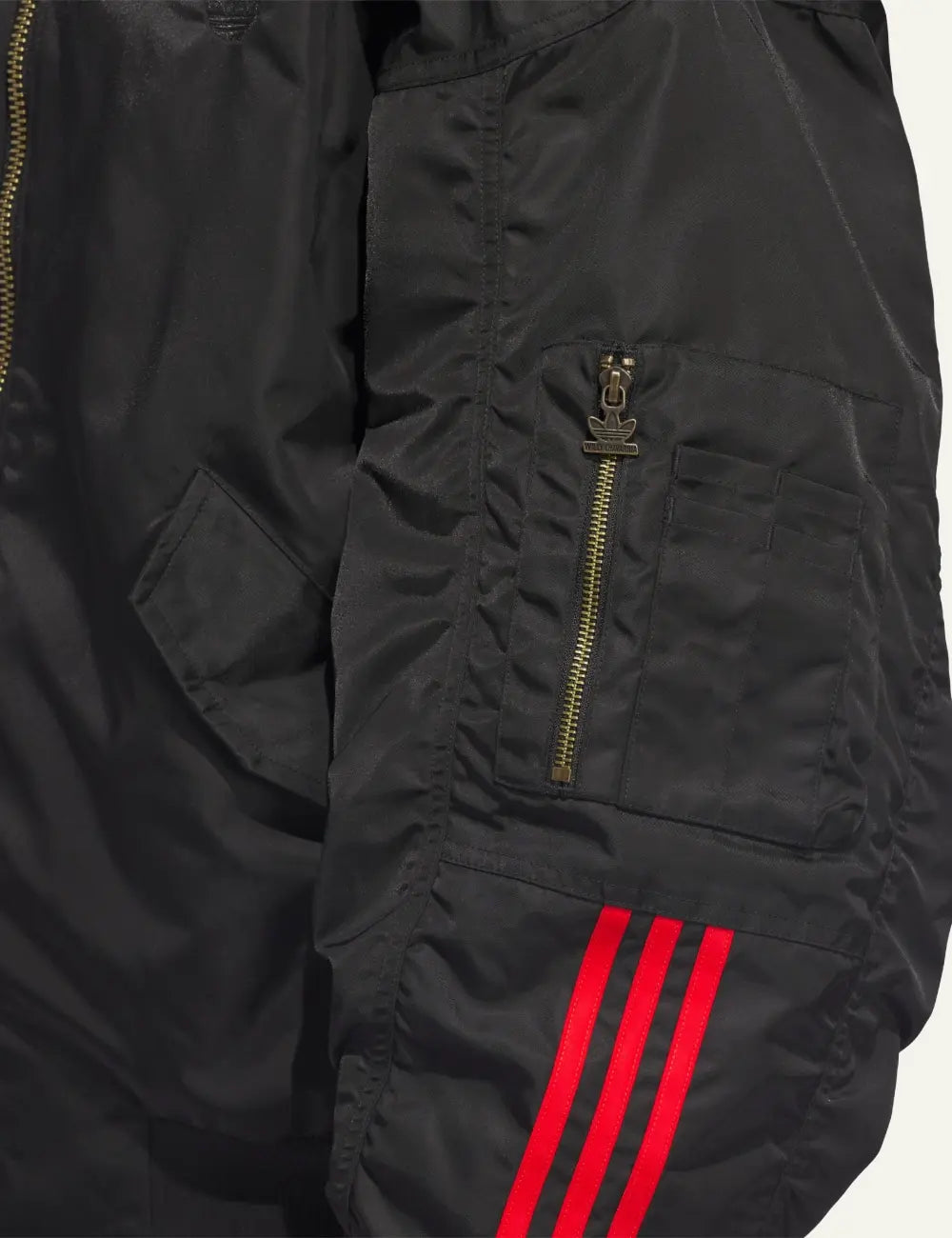 Close-up detail of sleeve pocket and red stripes on Adidas x Willy Chavarria satin bomber.