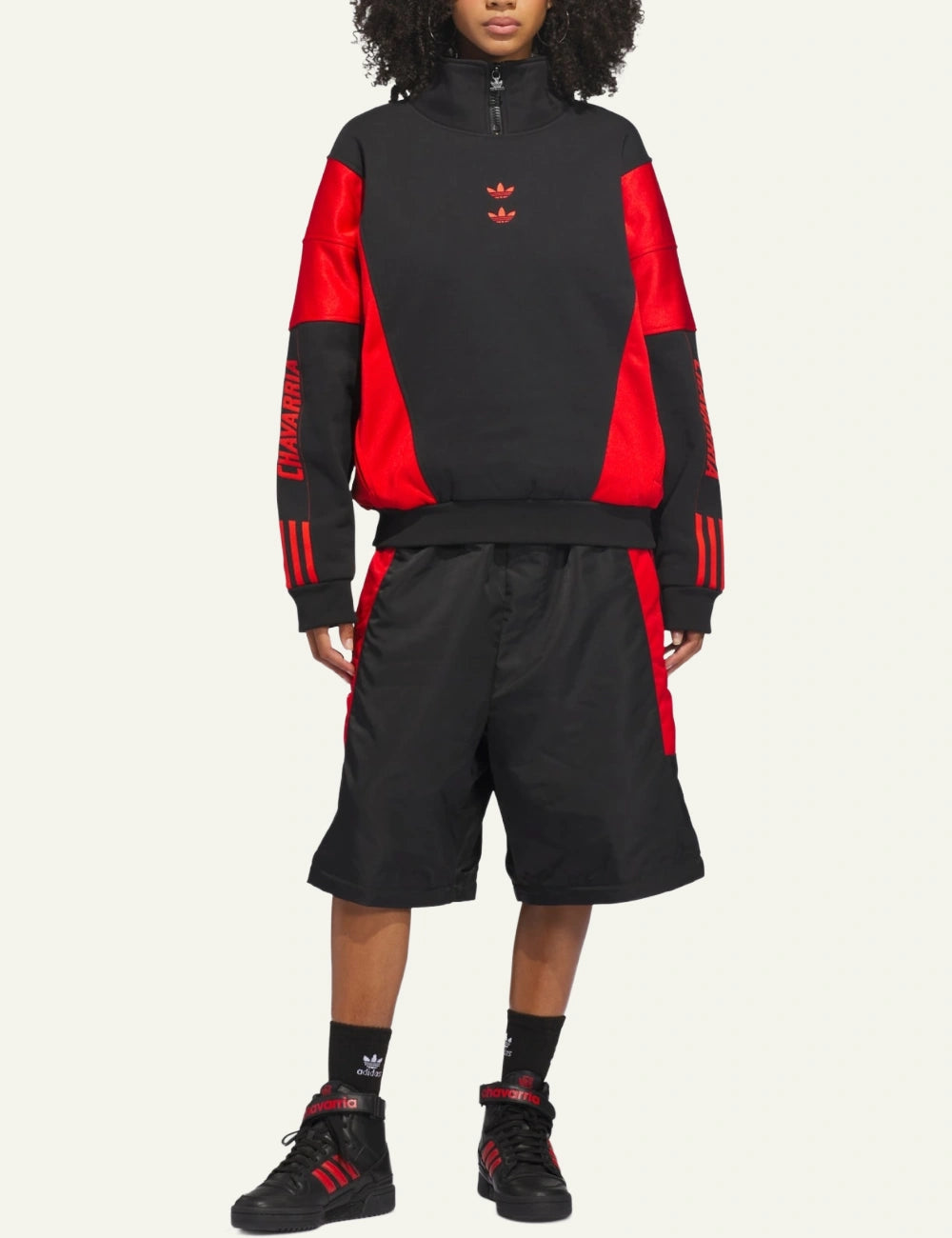 Full outfit with Adidas x Willy Chavarria Watsonville mockneck jumper styled με red–black oversized shorts.