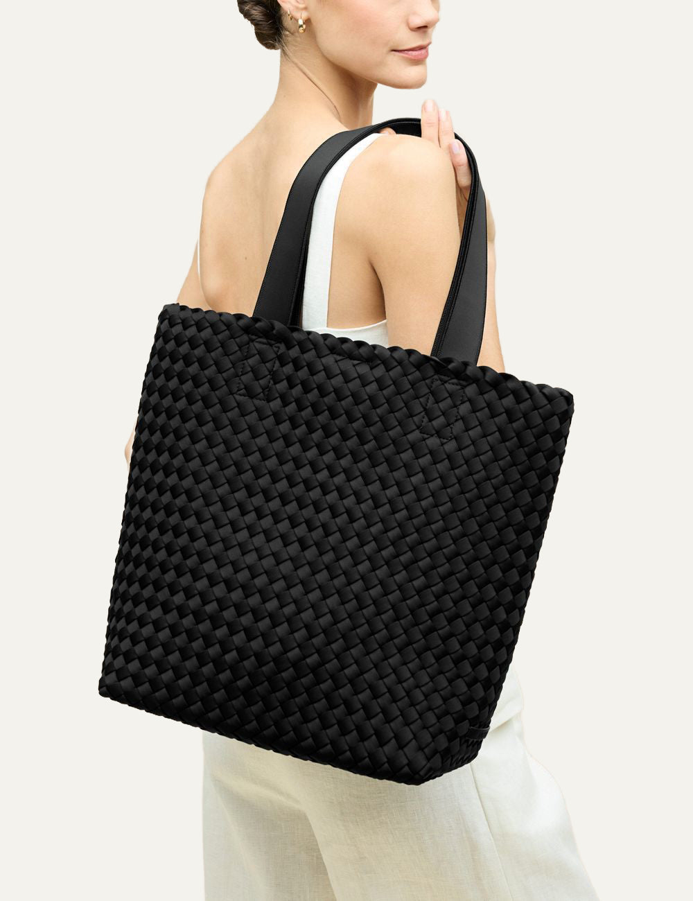 Black woven neoprene tote bag worn on shoulder, oversized everyday shopper Como Shopper Tote Solid Onyx