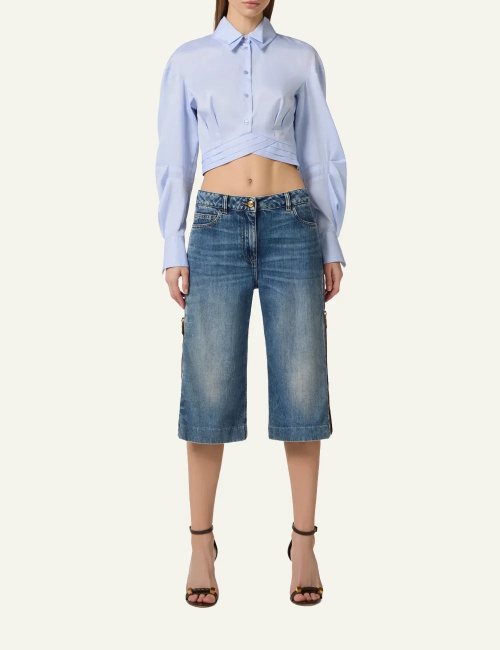 Model wearing Elisabetta Franchi white knit mini dress with camel stripes and statement belt – chic fitted outfit