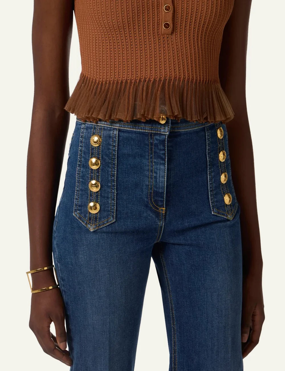 Close-up of Elisabetta Franchi palazzo jeans showing gold button embellishments και structured high-waist panel.