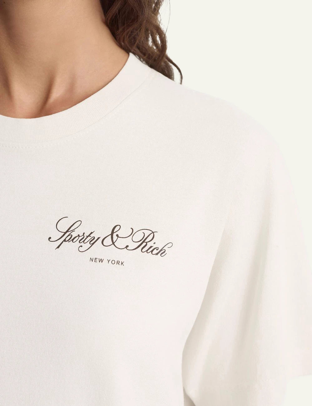 Sporty and Rich ecru logo tee relaxed fit front detail view
