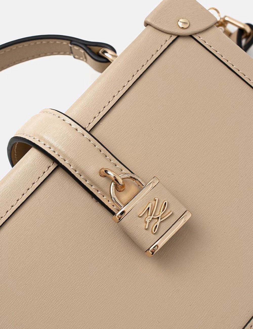 Detail – padlock & leather Karl Lagerfeld safari trunk bag padlock logo leather detail close up