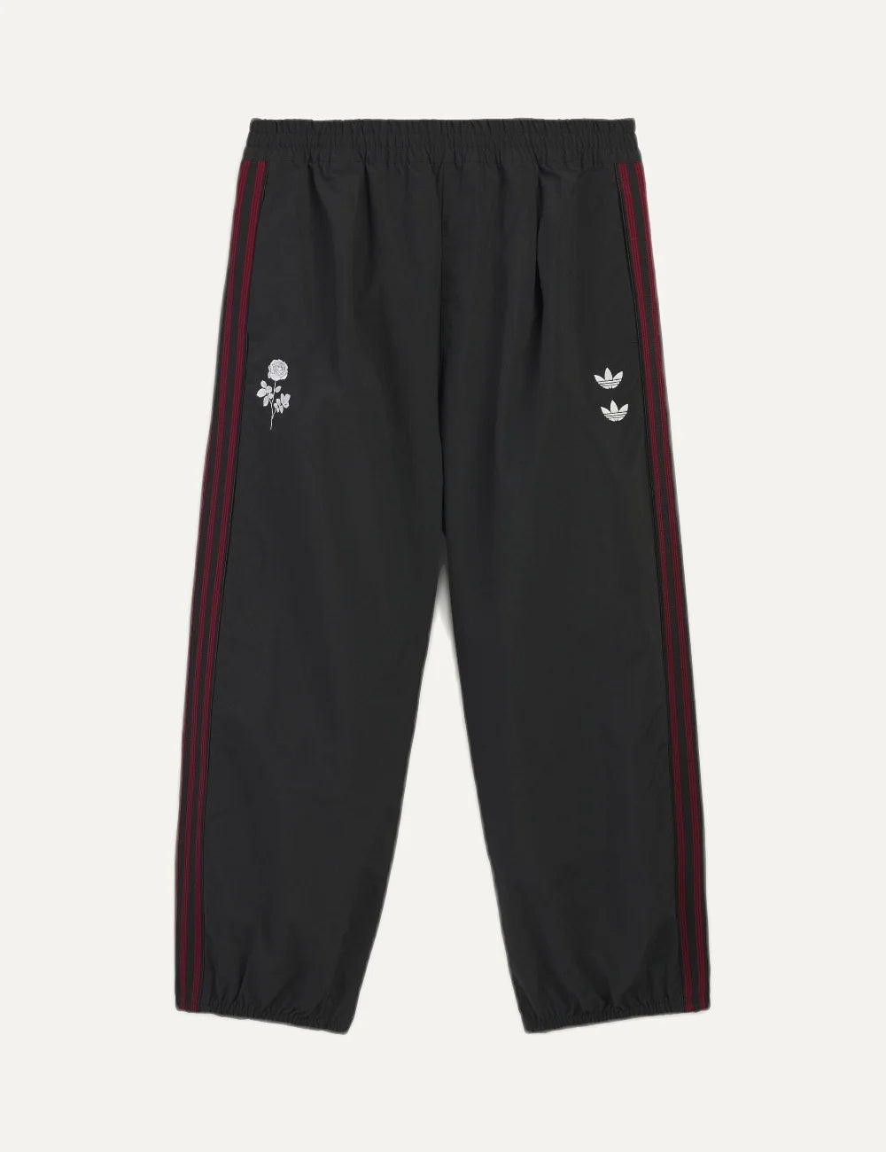 Men's adidas black woven track pants with burgundy side stripes, embroidered logos and rose artwork