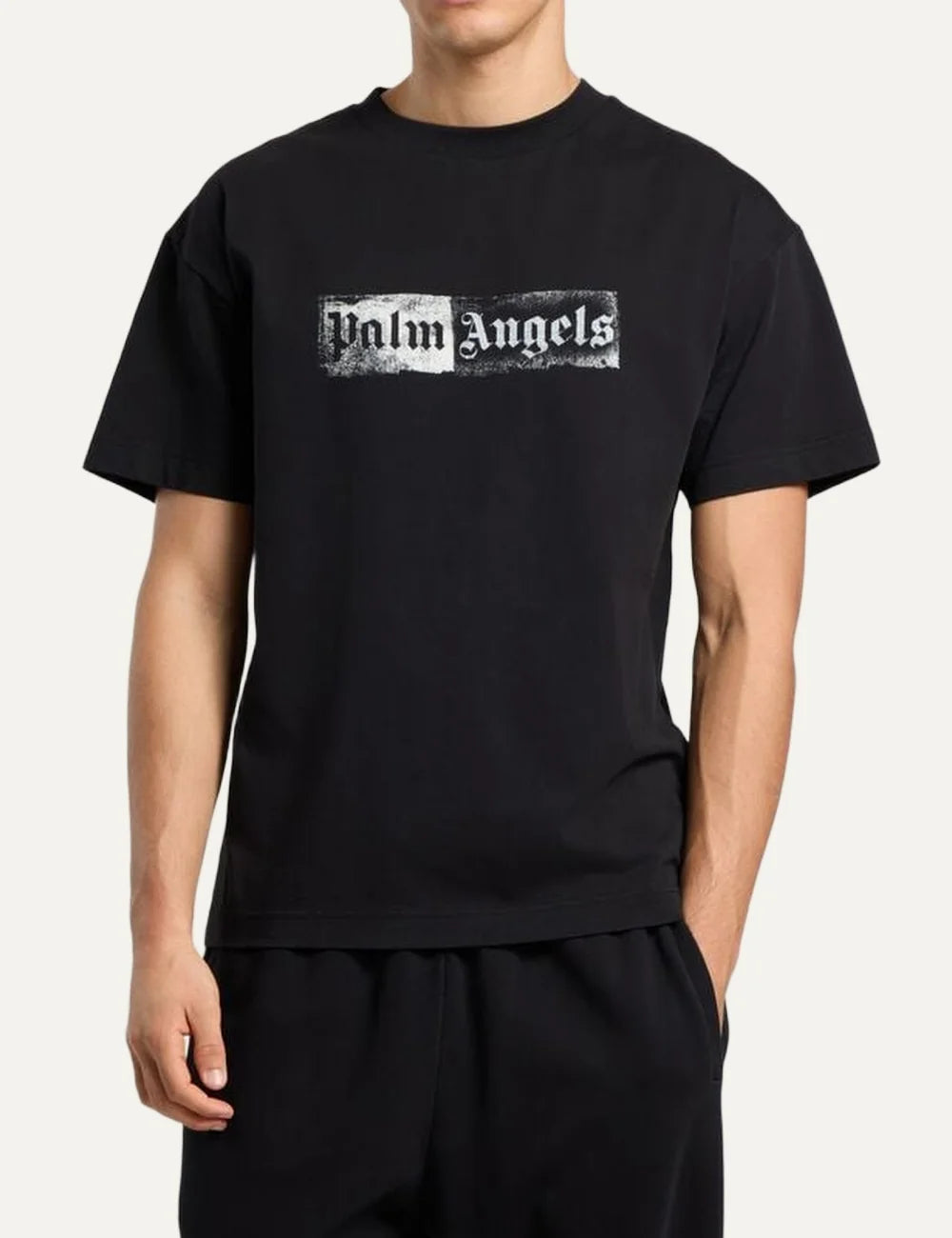 Palm Angels men's black cotton crew neck T-shirt with short sleeves and a white distressed rectangular stamp logo print on the chest model