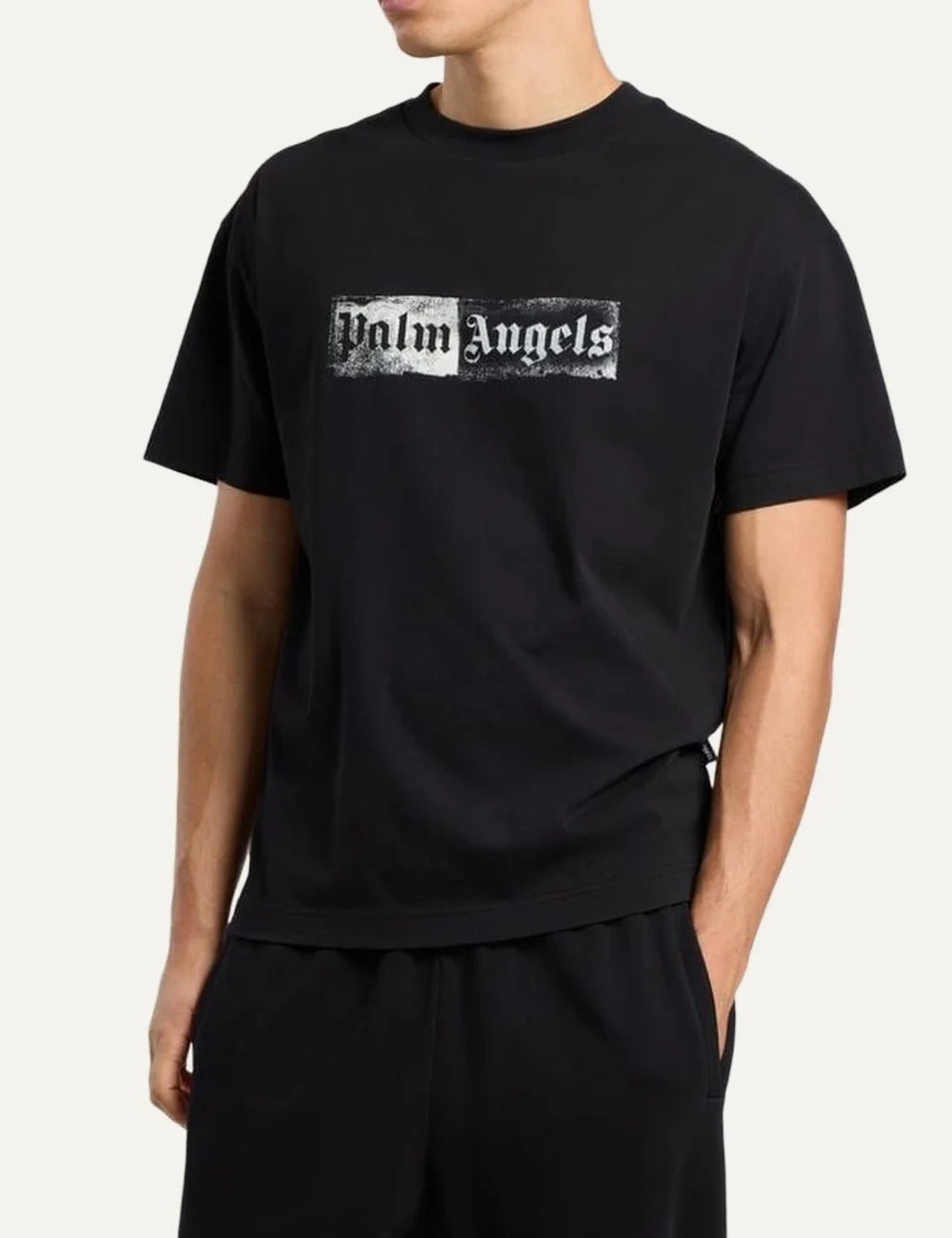 Palm Angels men's black cotton crew neck T-shirt with short sleeves and a white distressed rectangular stamp logo print on the chest side