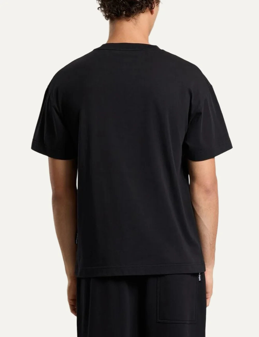 Palm Angels men's black cotton crew neck T-shirt with short sleeves and a white distressed rectangular stamp logo print on the chest back