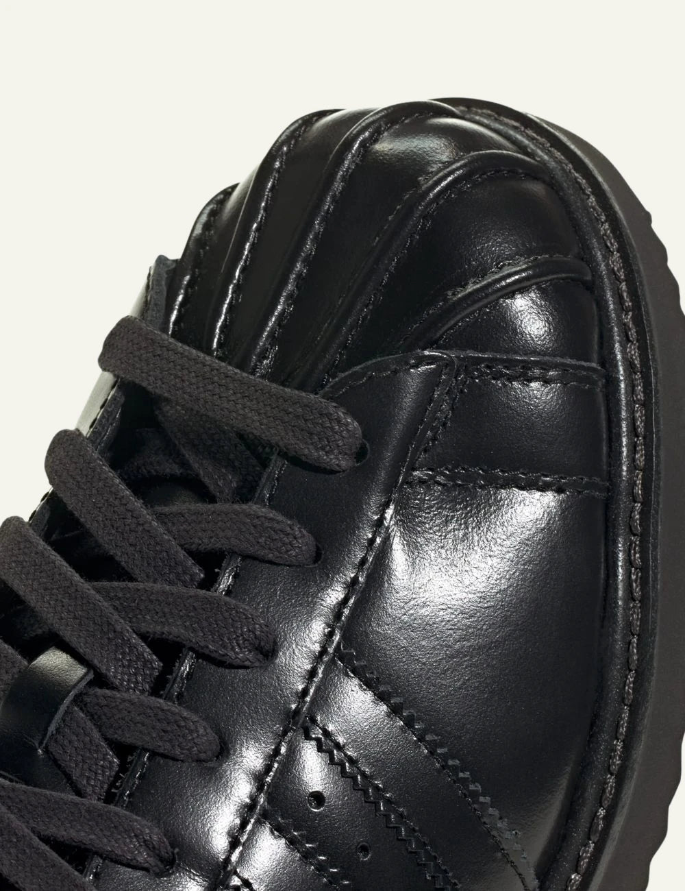 Women's adidas Originals Superstar Lux black leather sneakers with shell toe and platform-inspired sole angled front