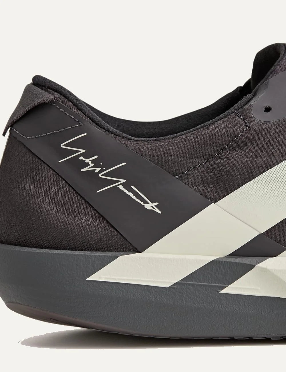 Y-3 Adios 9 sneaker black me off white stripes side detail view