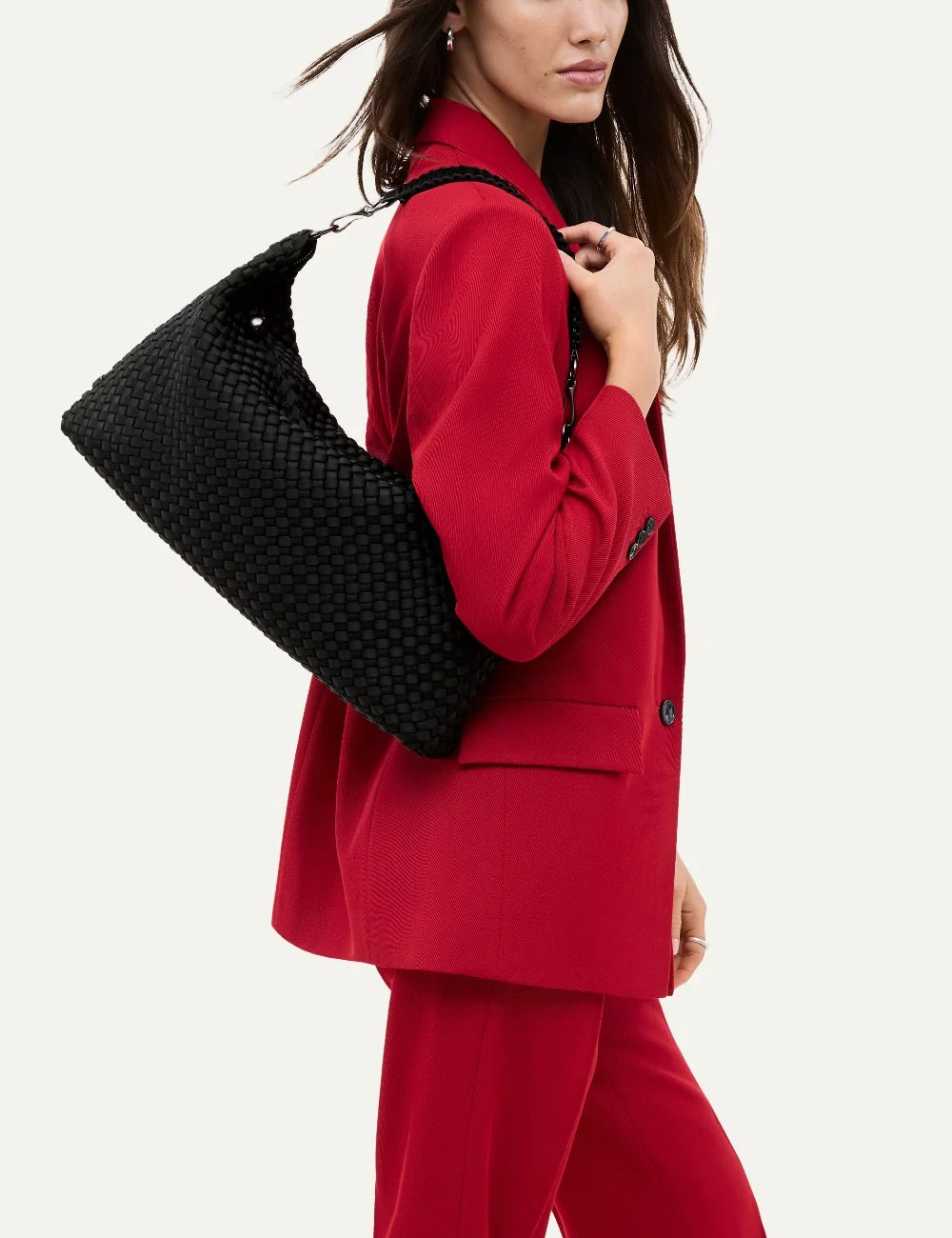 Women's Naghedi Porto Medium Half-Moon Bag in true black handwoven neoprene with shoulder strap on model