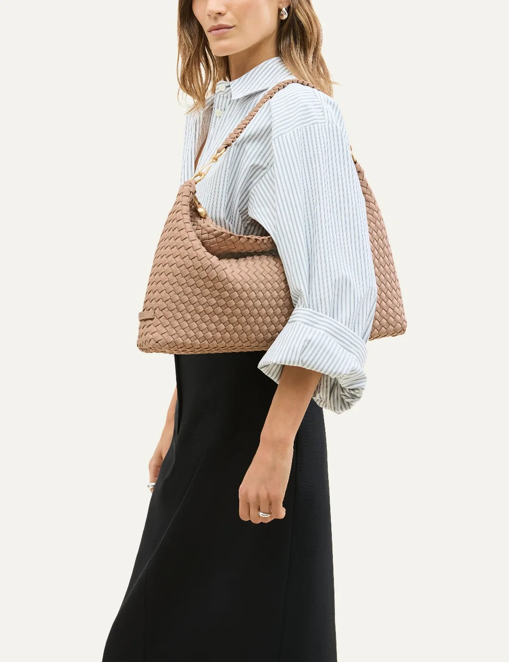 Women's Naghedi Porto Medium Half-Moon Bag in light mocha handwoven neoprene with shoulder strap on model