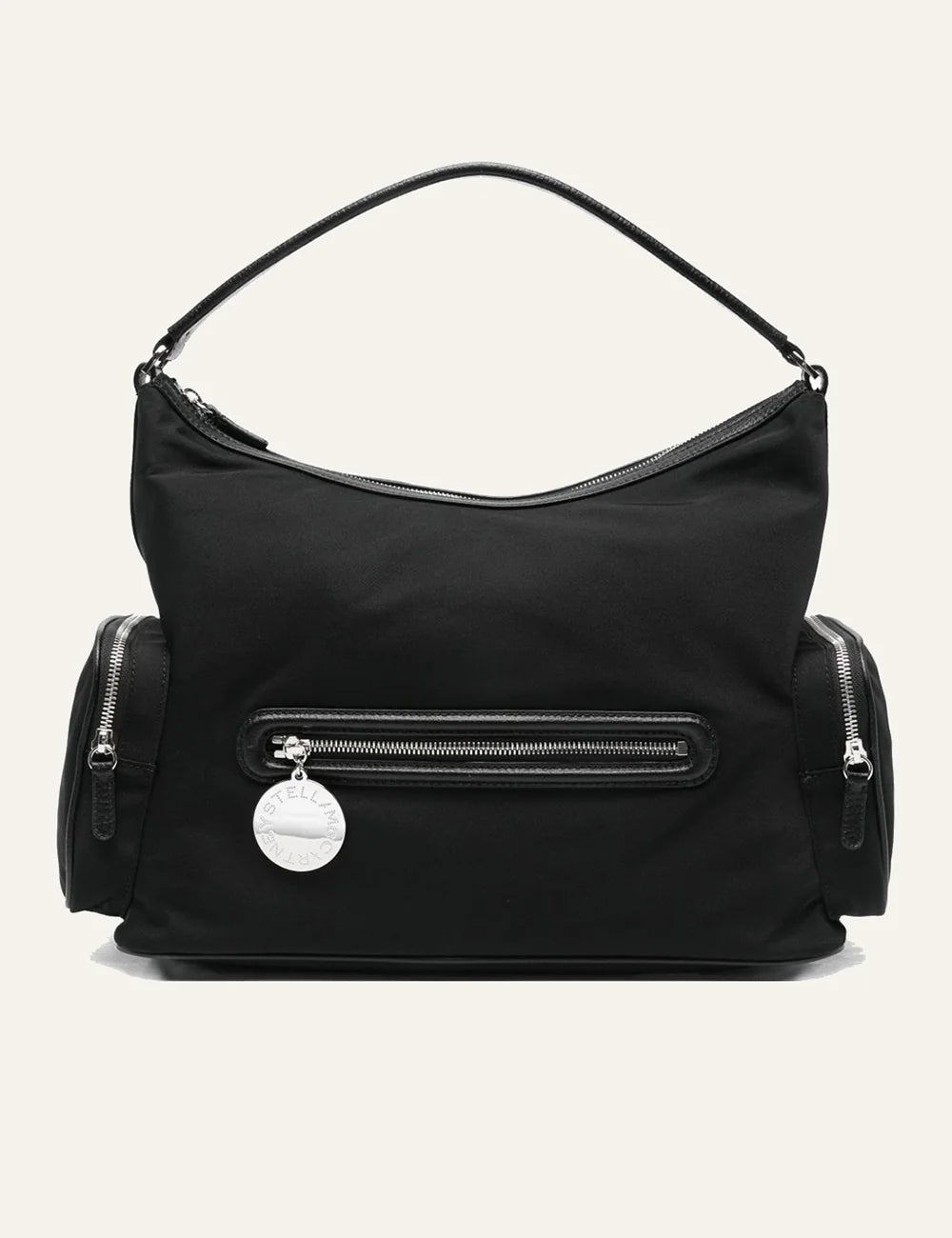 “Stella McCartney Dartmoor shoulder bag σε black nylon με front zip pocket και signature round logo charm.”