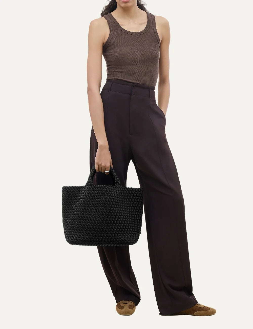 Women's Naghedi St. Barths Medium Tote in true black handwoven neoprene with woven handles on model
