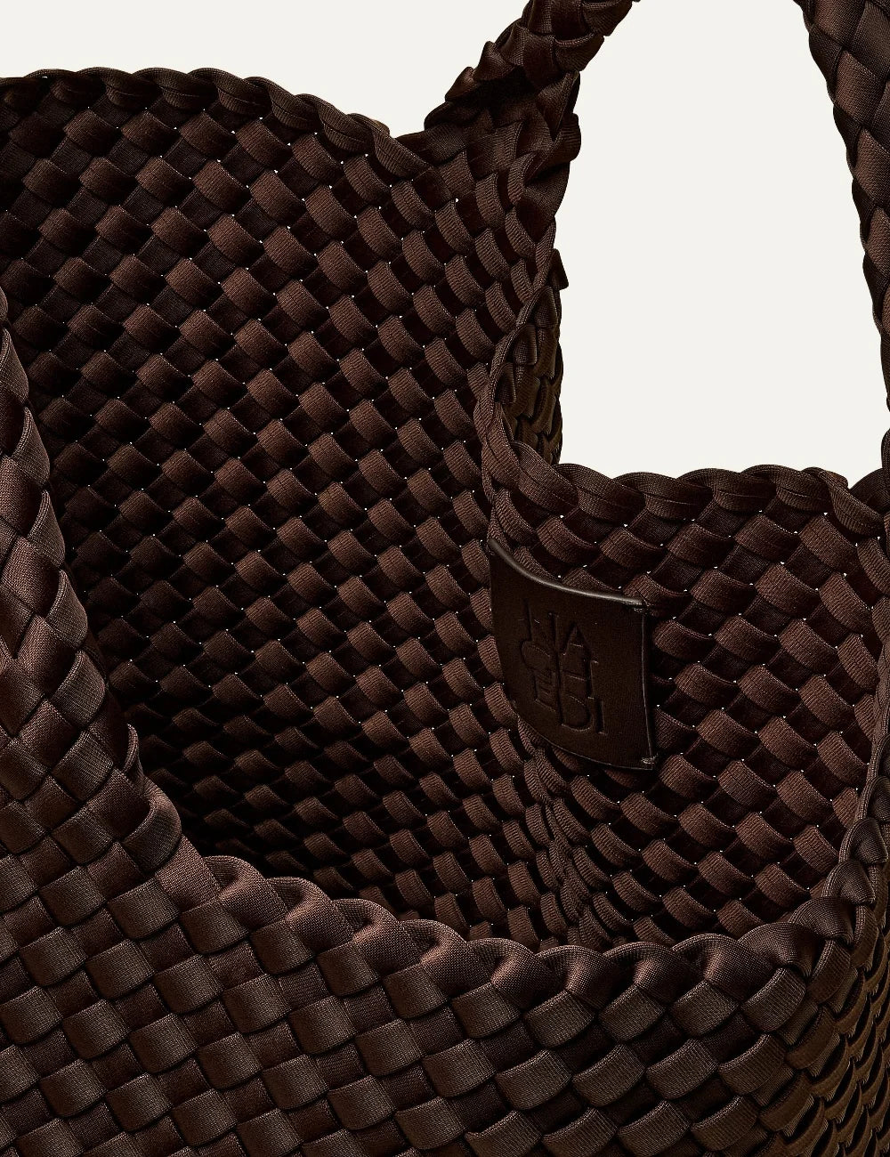 Women's Naghedi St. Barths Medium Tote in dark chocolate brown handwoven neoprene with woven handleslogo patch view