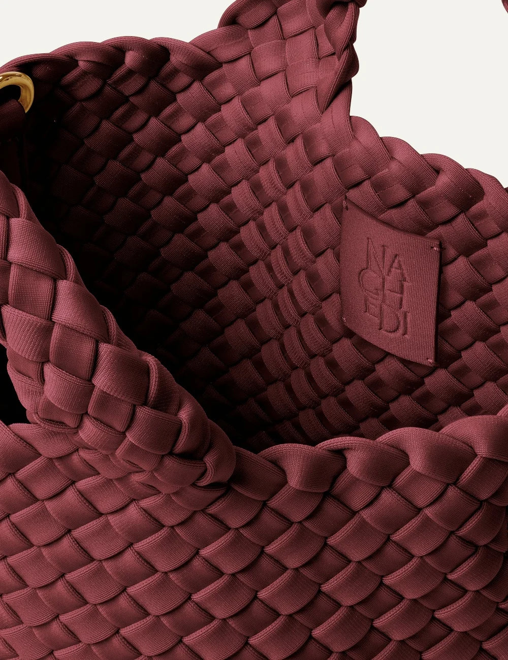 Women's Naghedi St. Barths Petit Tote in Bordeaux burgundy handwoven neoprene with detachable crossbody strap logo patch detail