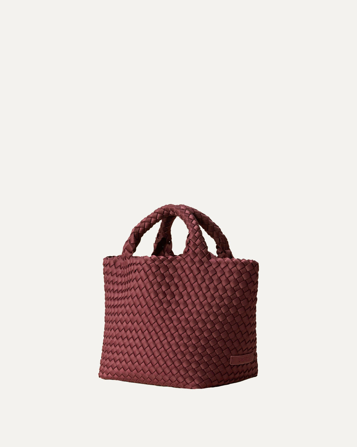 Women's Naghedi St. Barths Small Tote in Bordeaux handwoven neoprene with top handles and adjustable crossbody strap side view