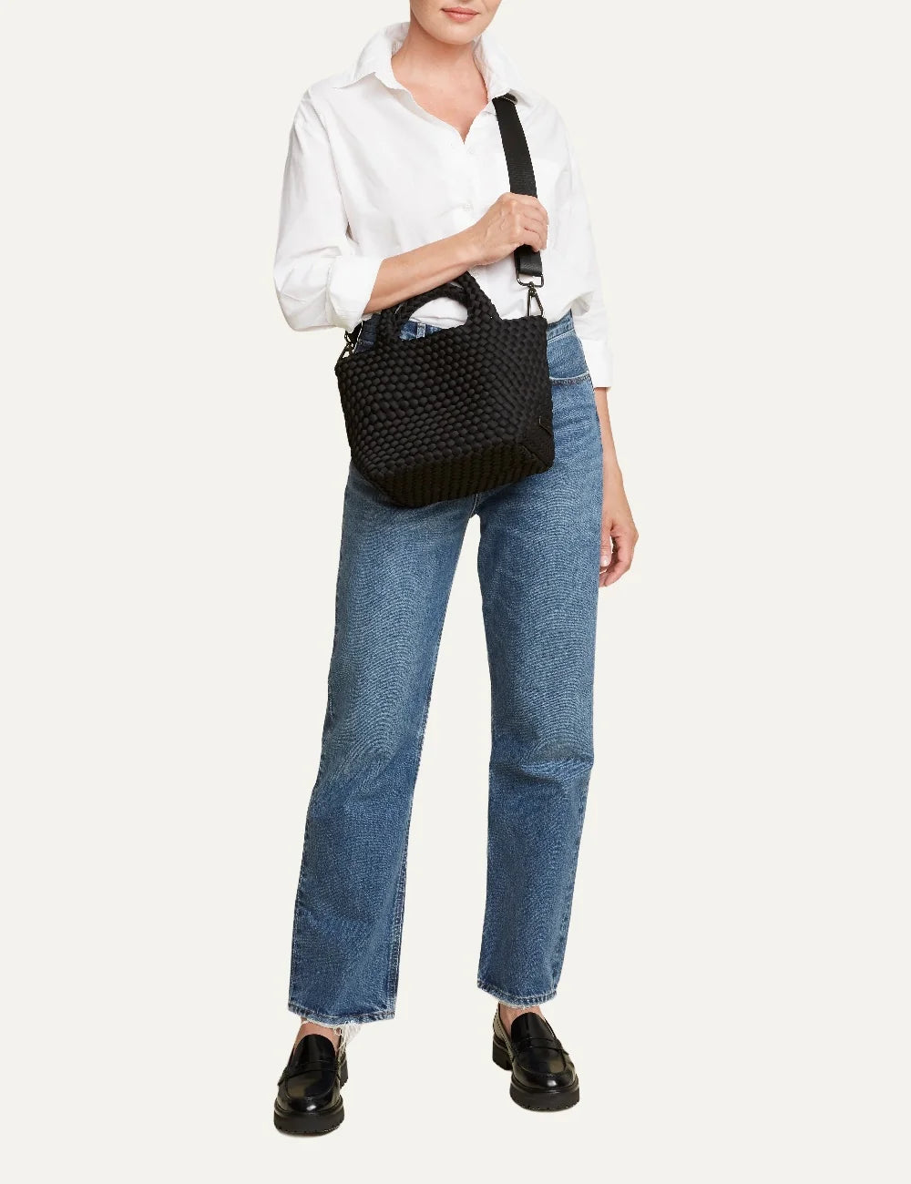 Women's Naghedi St. Barths Small Tote in black handwoven neoprene with top handles and adjustable crossbody strapon model