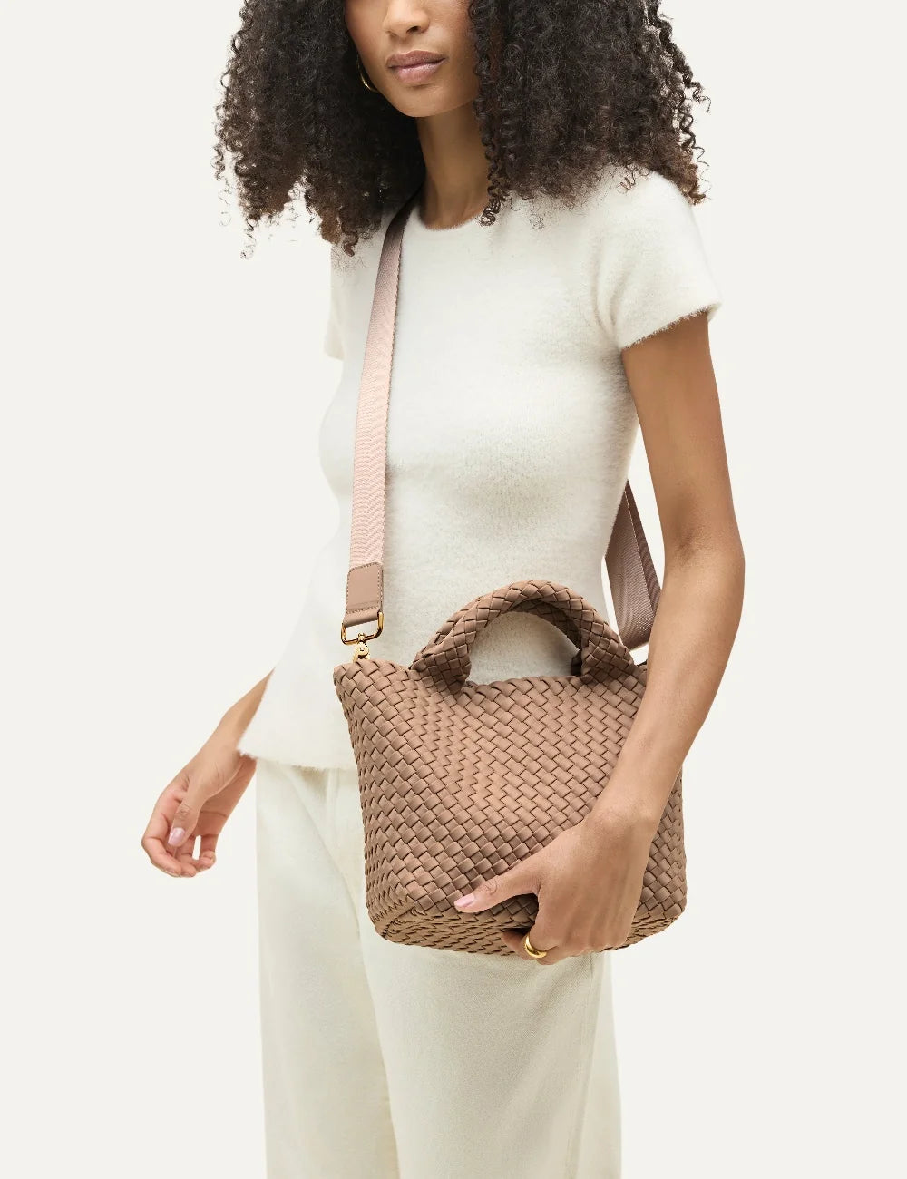 Women's Naghedi St. Barths Small Tote in Seychelles beige handwoven neoprene with top handles and adjustable crossbody strap on model