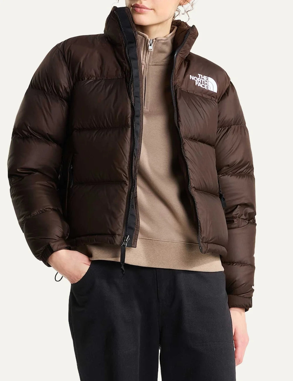 The North Face women's 1996 Retro Nuptse puffer jacket in dark chestnut brown with quilted down panels, high collar, front zip and white chest logo detail