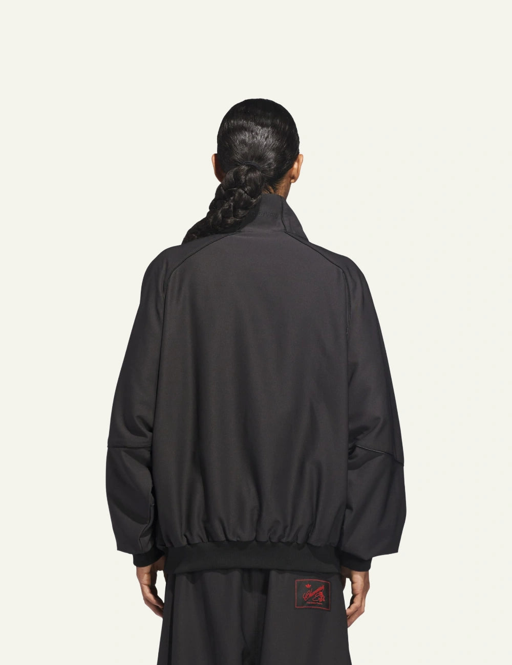 Back view of Adidas x Willy Chavarria twill jacket με ψηλό γιακά και clean silhouette.”