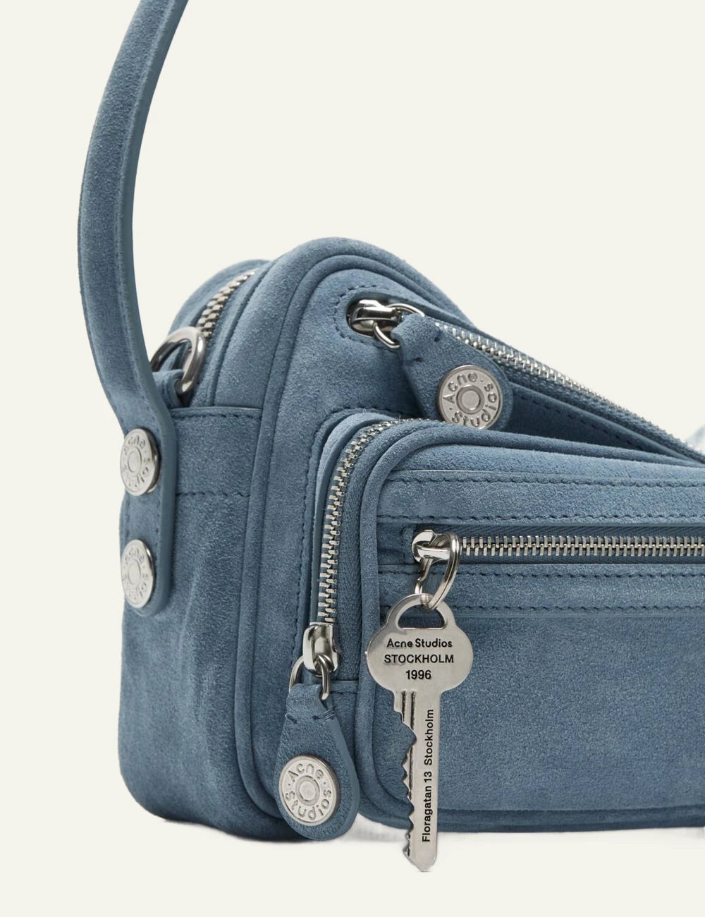 Acne Studios light blue suede shoulder bag with multiple zip pockets and silver-tone hardware side flat view
